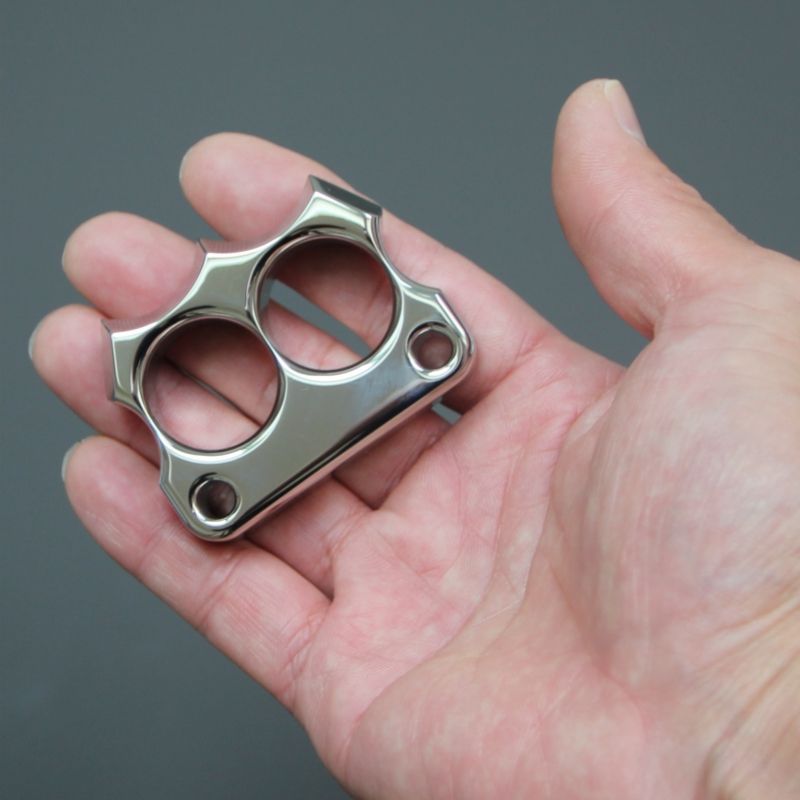 Open palm holding the mirror polished 316 steel two-hole mini duster.