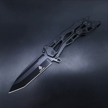 All-black all-steel folding knife open on dark background