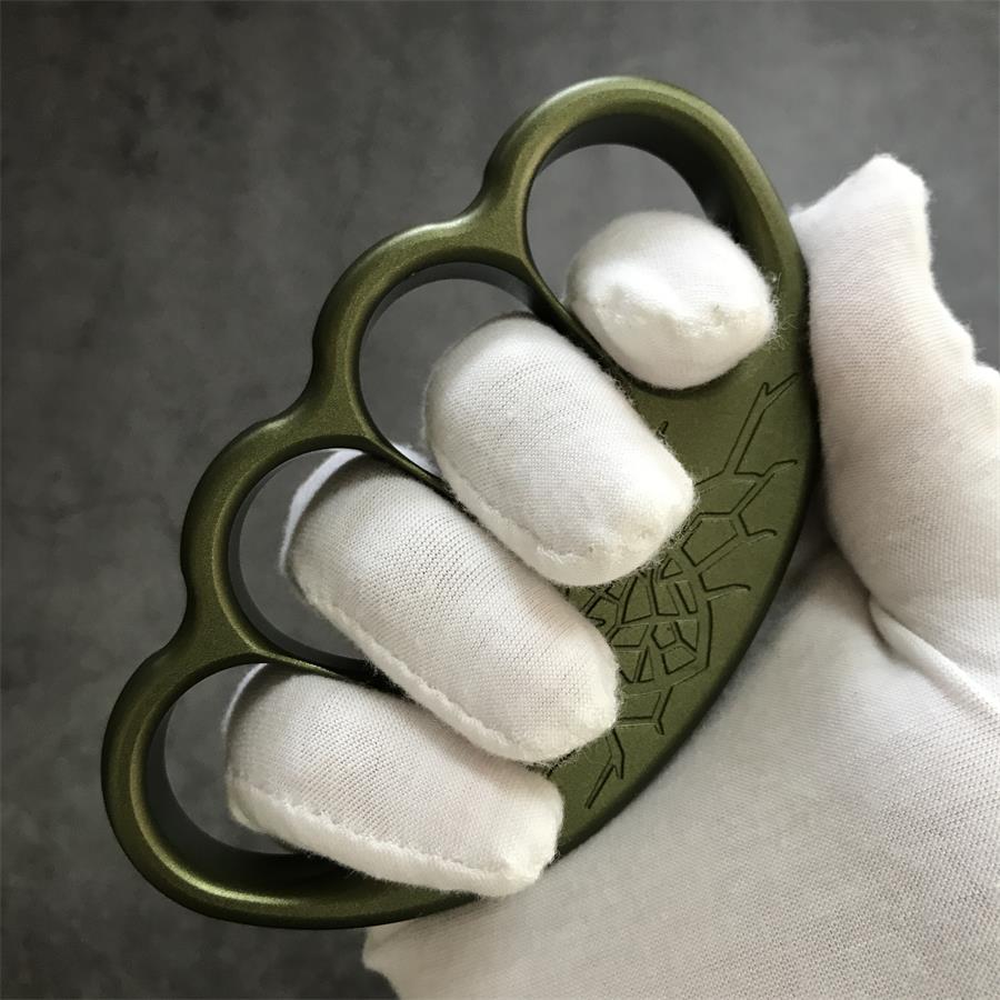 Angled grip view of olive duster with crest engraving on dark backdrop