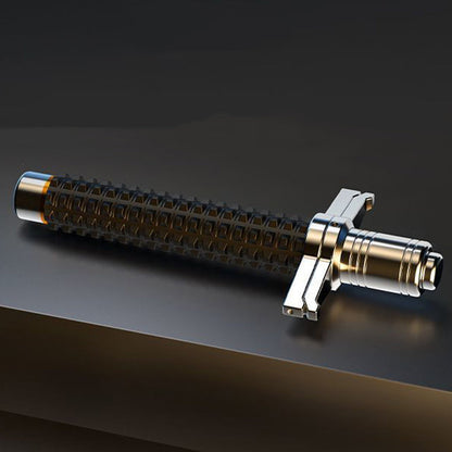 Collapsed aviation alloy steel baton lying on a dark surface showing textured grip and guard