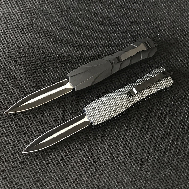Black and gray OTF knives closed showing handles and clips