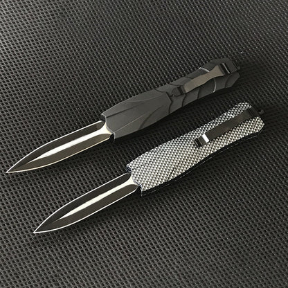 Black and gray OTF knives closed showing handles and clips