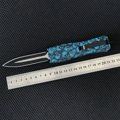 Two pocket knives beside a metal ruler showing overall length