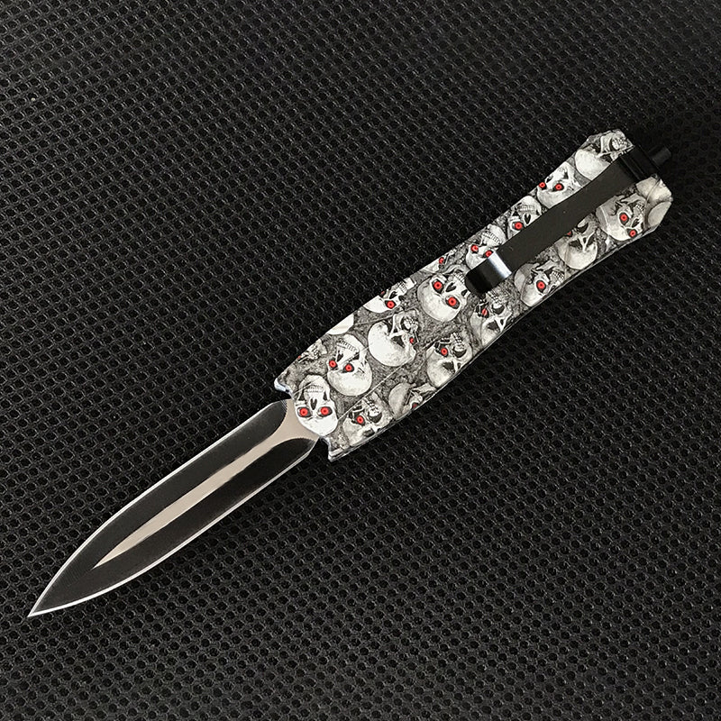 White skull patterned EDC knife with blade extended side view