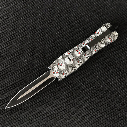 White skull patterned EDC knife with blade extended side view