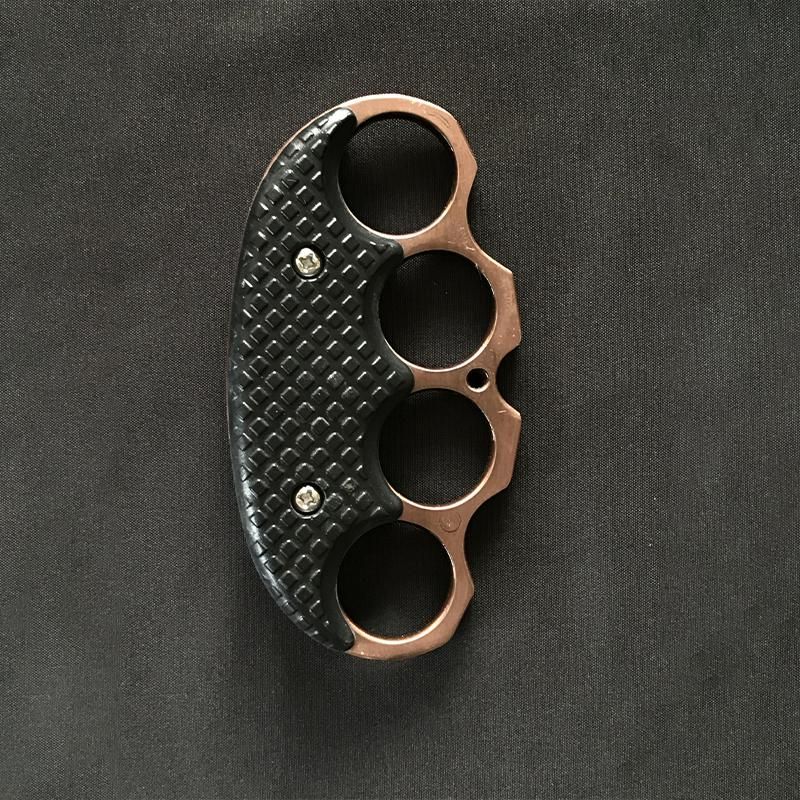 All-black covered EDC knuckle duster laid flat on a white background, first view.