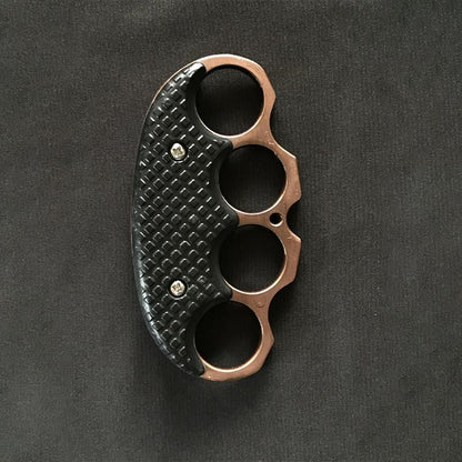 All-black covered EDC knuckle duster laid flat on a white background, first view.