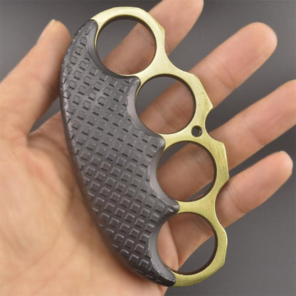 Gold-ring black-covered EDC knuckle duster held in a palm, showing the textured black grip.