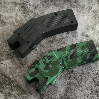 Black and green camouflage pistol-grip stun gun units lying flat showing the U-shaped head notch, top vent slots and textured diamond grip panels