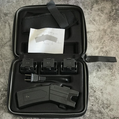 Black zippered hard case laid open showing the black stun gun unit, three KT launcher cartridges, wall charger cable, nylon holster and the printed user manual diagram