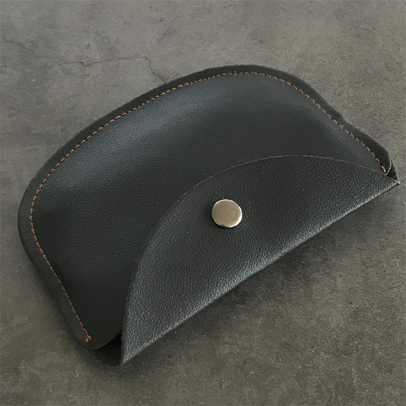 Side profile of the closed leather case showing the curved flap edge and perimeter stitching