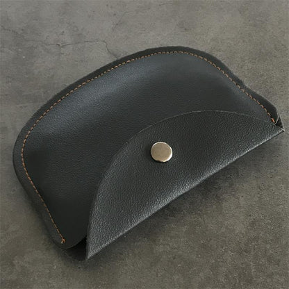 Side profile of the closed leather case showing the curved flap edge and perimeter stitching
