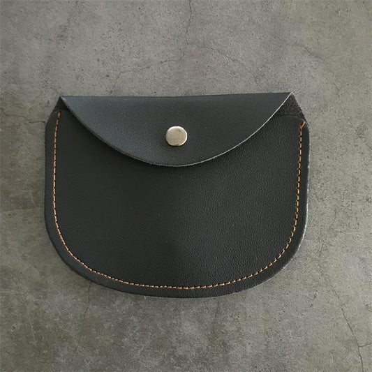 Closed black leather knuckle dusters case with the curved flap over a silver snap and orange stitching