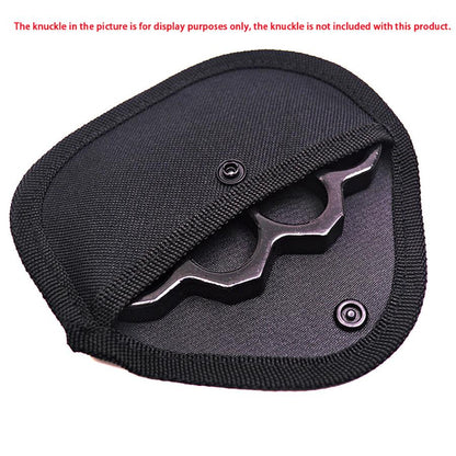 Black nylon knuckle sleeve with its snap flap open, holding a black knuckle duster shown for display purposes only