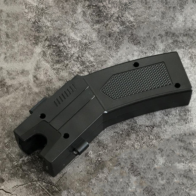 Single black pistol-grip stun gun unit lying flat showing the U-shaped head notch, vent slots and diamond-textured grip panel