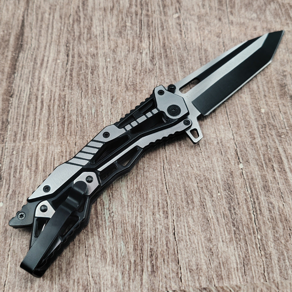 Black and silver all-steel folding knife open on wood surface