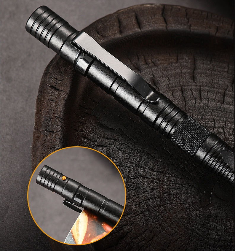 A black tactical pen resting diagonally on a dark textured surface, showing the flat pocket clip, ridged barrel segments and a knurled grip near the lower end, with an inset close-up of the top end and its small orange button.