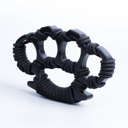 Black woven knuckle duster on a white background showing the four openings, wrapped palm base and pointed tail spur