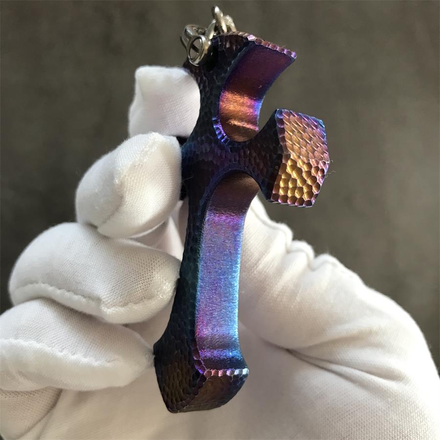 Side profile of Blaze finish titanium cross pendant showing thickness and burnt blue purple colour gradient