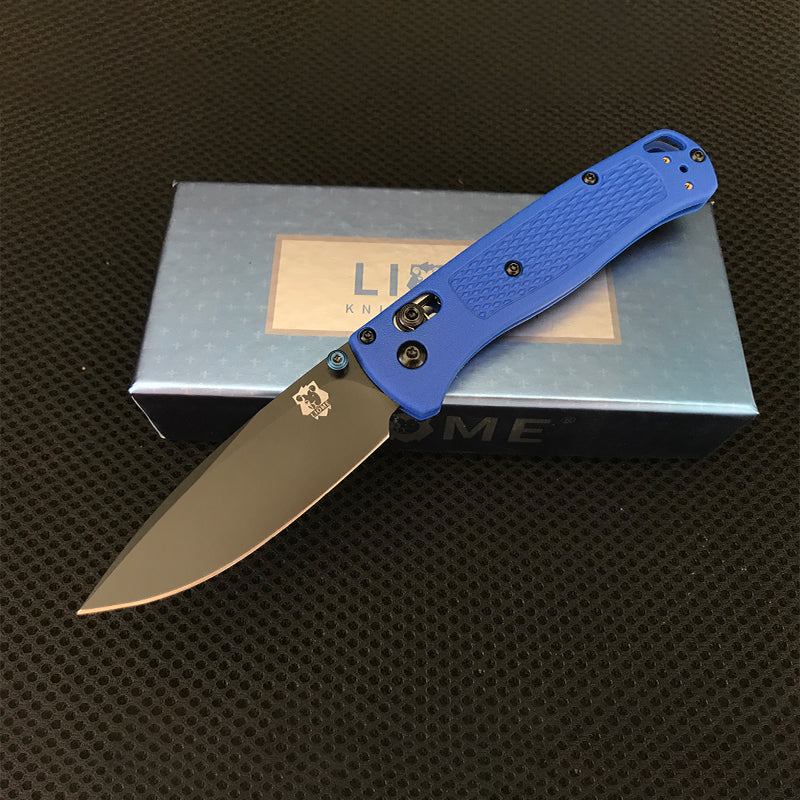 Blue handled folding knife with black-coated drop-point blade open on top of a Liome branded box