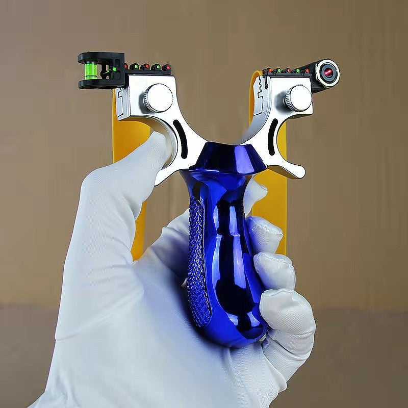 Blue slingshot held in a white gloved hand with the bubble level and laser module facing out