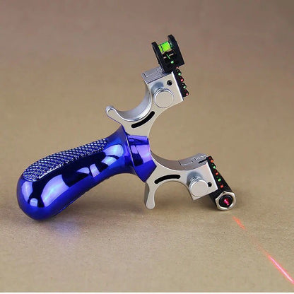 Blue slingshot lying on cardboard with the laser switched on, a red line running across the surface
