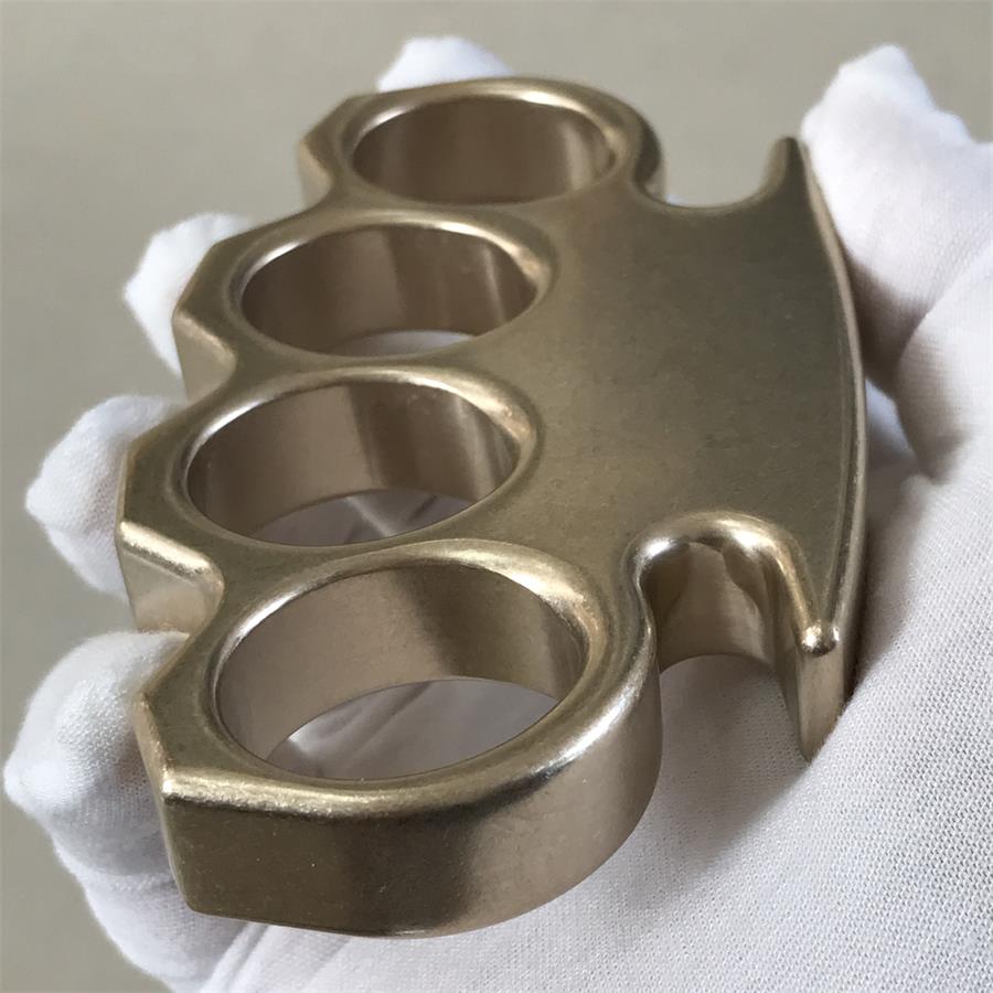 Close-up side view of the stonewashed brass knuckle duster revealing deep finger holes.