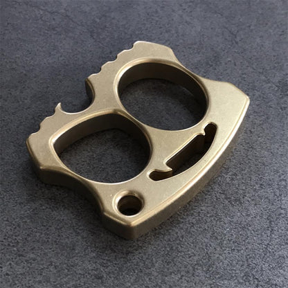 Brass knuckle angled view with jagged edge and smile cutout centered