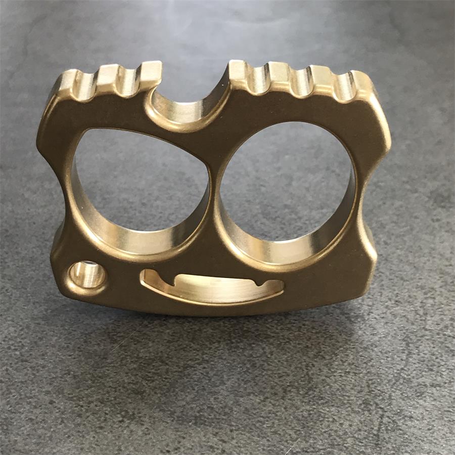 Brass two-hole knuckle upright with segmented top teeth on grey countertop