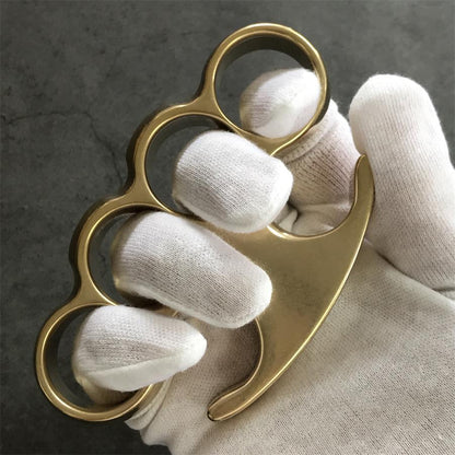 White-gloved fist wearing the brass knuckle duster, claw tip pointing past the little finger