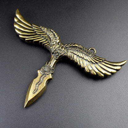Close view of the bronze eagle pendant showing feathered wings, the hanging ring and the snake motif coiled on its dagger style point