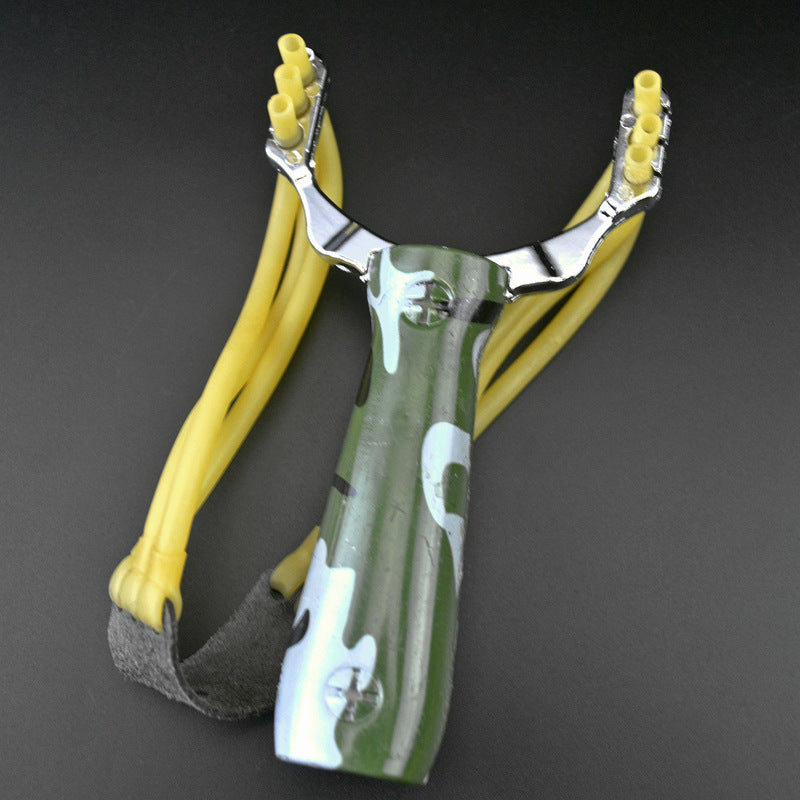 Camouflage water transfer slingshot with green patterned handle and yellow band strands on a dark grey background