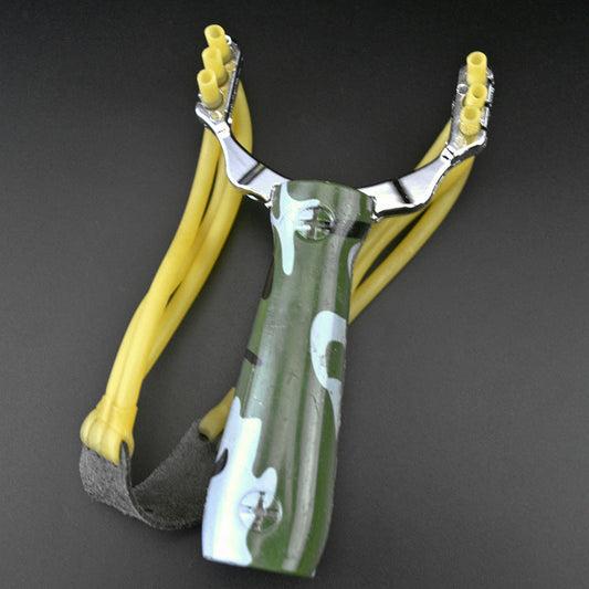 Camouflage water transfer slingshot with green patterned handle and yellow band strands on a dark grey background
