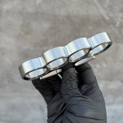 Profile side view of the 304 stainless steel classic knuckle duster worn on a gloved fist.