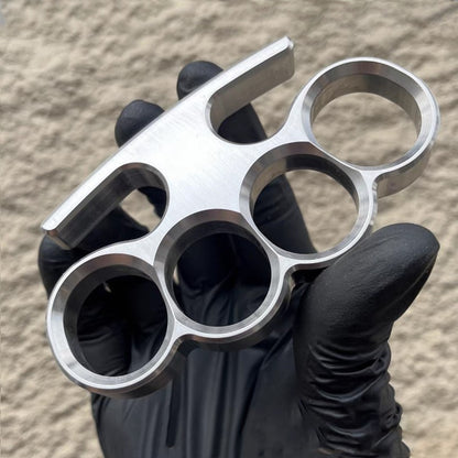 Side profile of the 304 stainless steel classic knuckle duster held by a black-gloved hand.