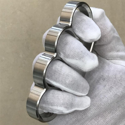 White-gloved fist wears the 304 stainless steel classic knuckle duster in a side pose.
