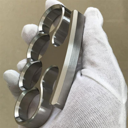 The 304 stainless steel classic knuckle duster shown from the profile side on a gloved hand.