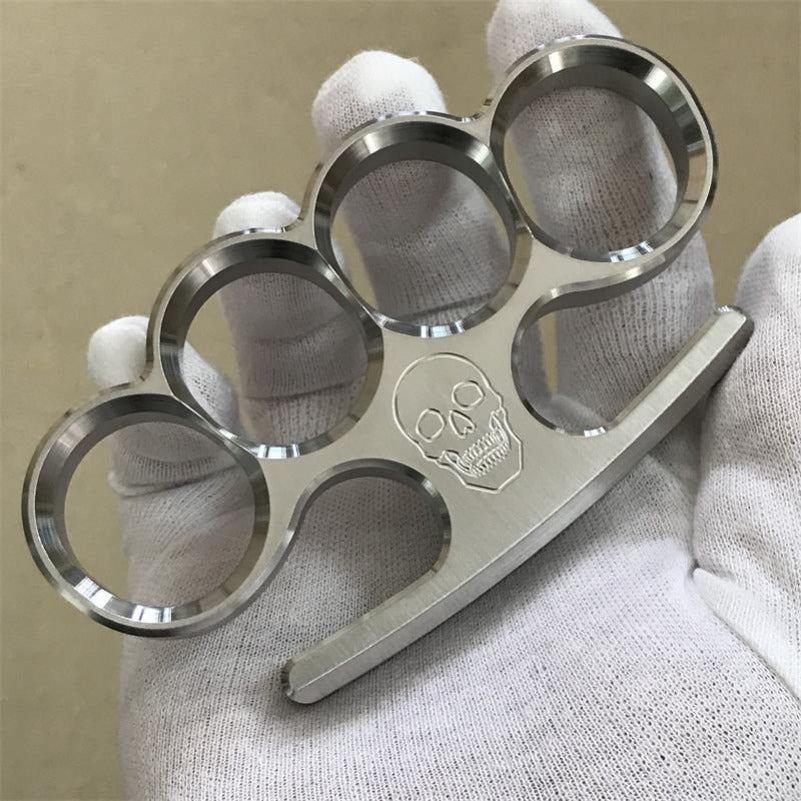 White-gloved hand displays the 304 stainless steel classic knuckle duster turned sideways.