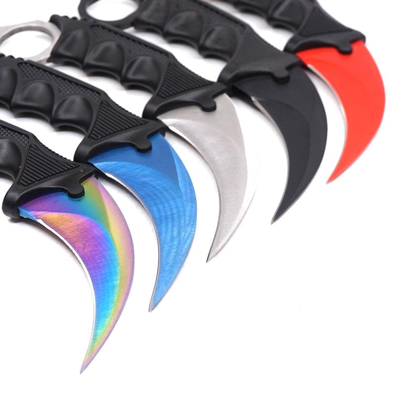 Close-up of five colorful karambit blades fanned out