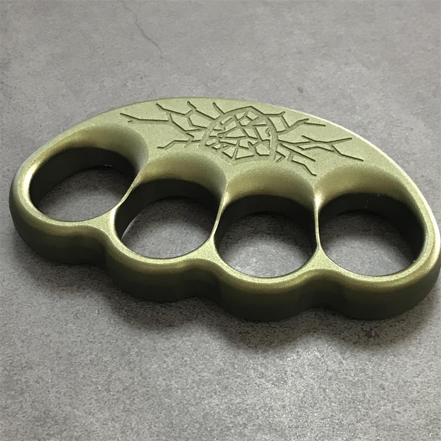 Olive knuckle duster resting flat with cracked crest centered