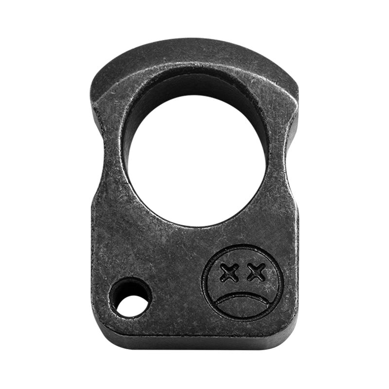 Dark single-hole knuckle weight front view on white showing the crossed-eye engraving and the corner hole