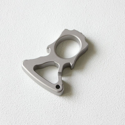 Angled flat lay of the stainless steel single-hole bottle opener duster.