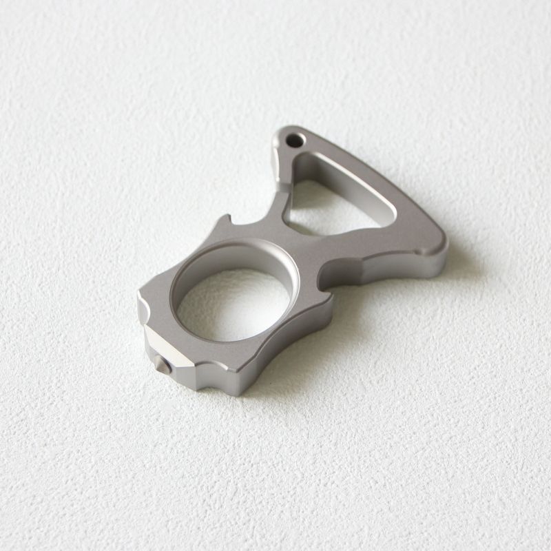 Single stainless steel single-hole bottle opener duster lying flat on white background.