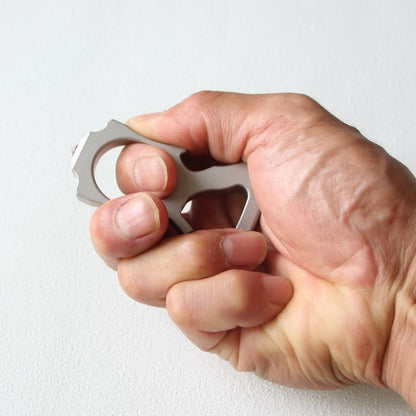 Hand gripping the stainless steel single-hole bottle opener duster to show fit.