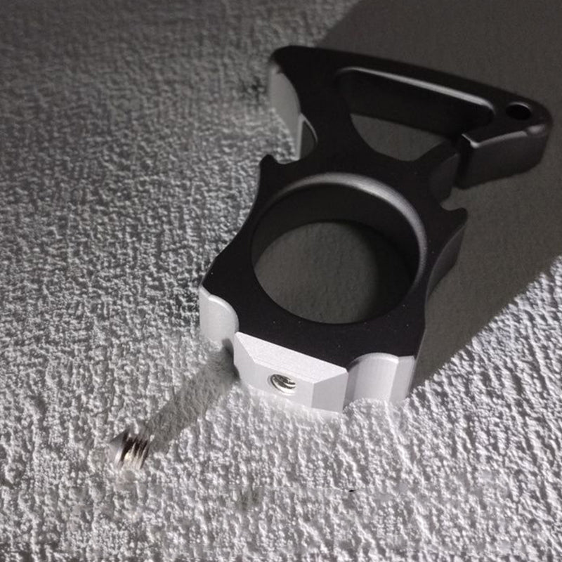 Stainless steel single-hole bottle opener duster lying on textured fabric surface.