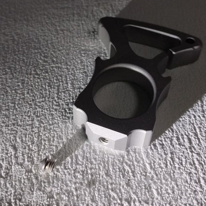 Stainless steel single-hole bottle opener duster lying on textured fabric surface.