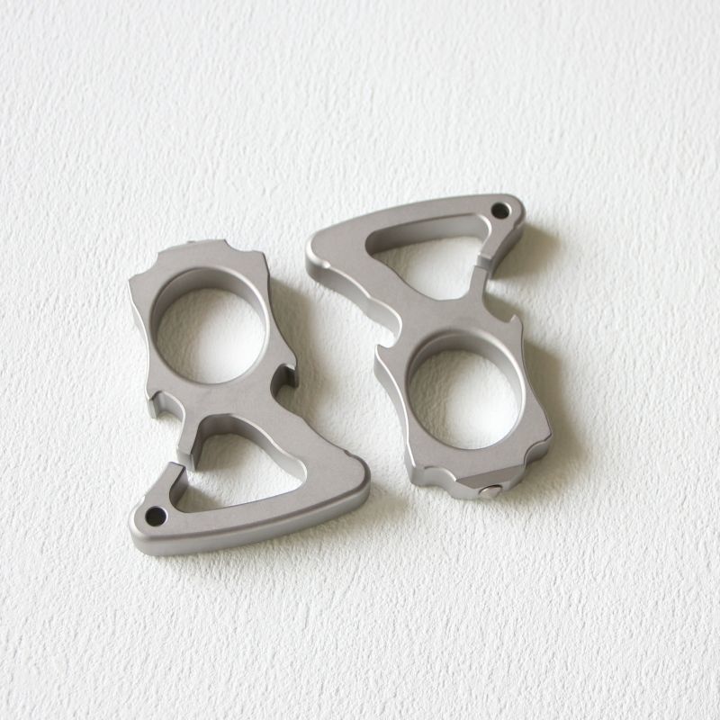 Two stainless steel single-hole bottle opener dusters placed side by side on white background.
