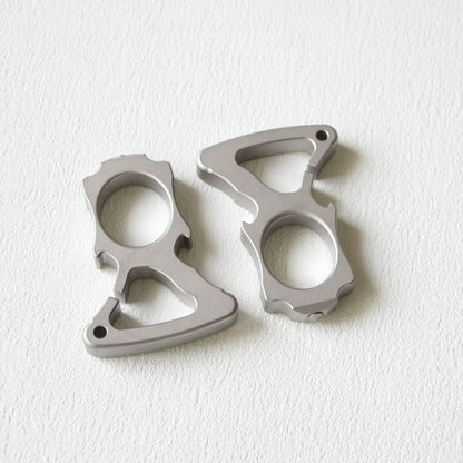 Two stainless steel single-hole bottle opener dusters placed side by side on white background.
