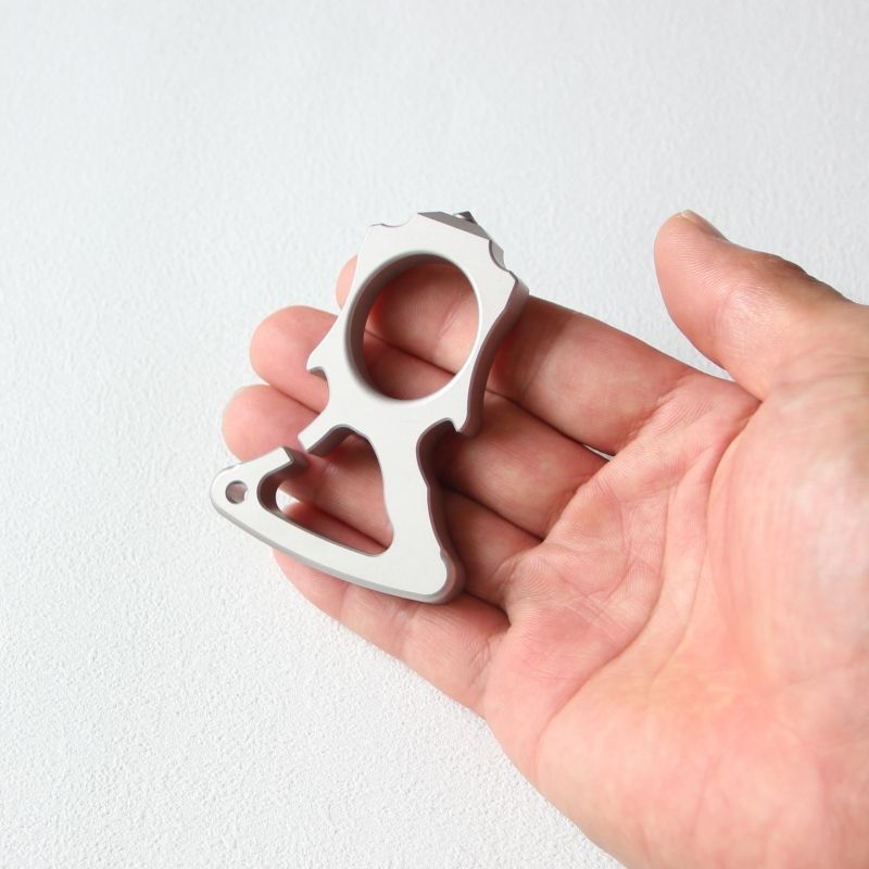 Palm view of the stainless steel single-hole bottle opener knuckle duster.