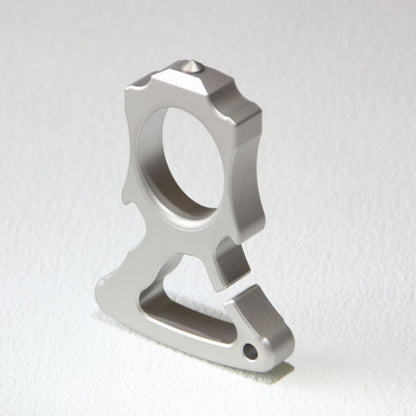 Upright front view of the stainless steel single-hole bottle opener knuckle duster.
